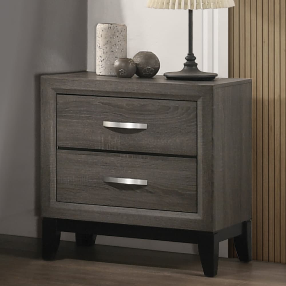 The forward design and clean lines of the Valdemar nightstand make it an ideal addition to any bedroom. This contemporary nightstand features a unique and subtle weathered gray finish. The nightstand features two large drawers that allow for storage of all kinds of household items.  With brushed nickel accents and tapered legs this transitional piece will add a touch of modern elegance and style to any bedroom.