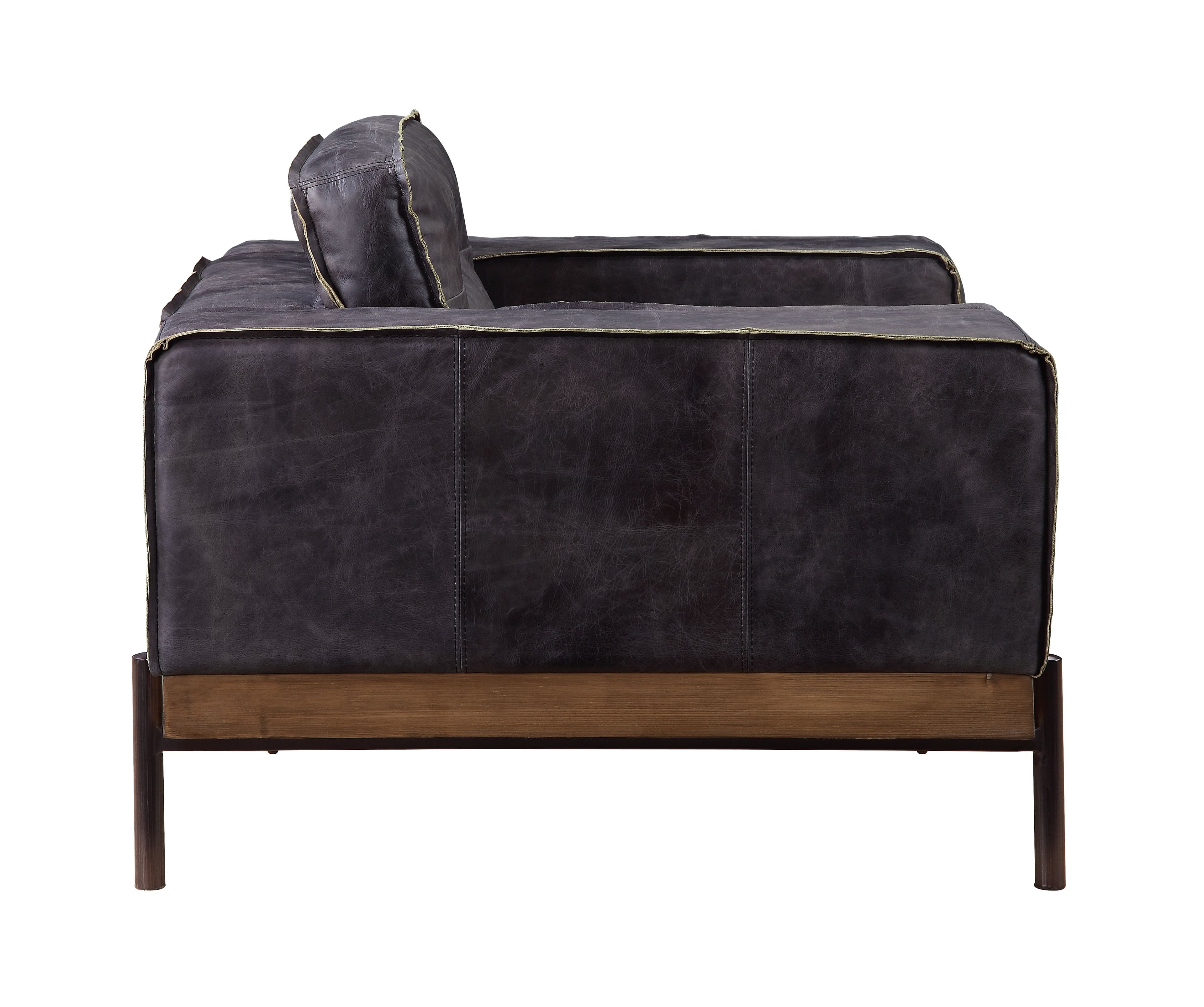 Part of the handsome Silchester Collection, this modern industrial chair will look great in any contemporary space. Contrast stitching makes the antique ebony top grain leather upholstery pop, and highlights the warm color of the wooden trim base. Metal spindle legs visually lighten the substantial proportions of this sofa set. Enjoy wide track arms and comfortable feather and foam seat construction, and relax in style.